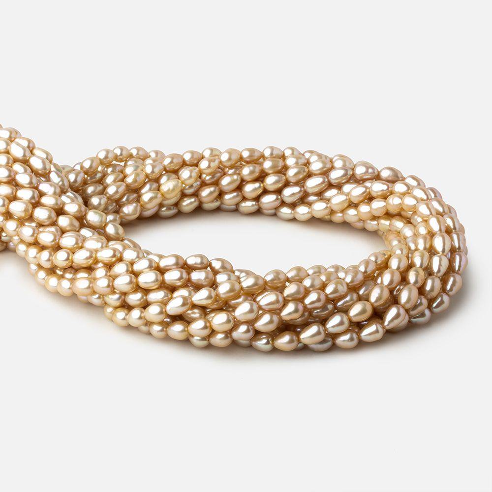 5.5x4.5-6.5x5mm Golden Beige straight drilled Oval freshwater pearls 16 inch 64 pieces A (ONLINE ORDER ONLY)