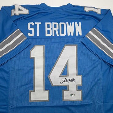 Autographed/Signed Amon-Ra St. Brown Detroit Current Blue Football Jersey Beckett BAS COA (ONLINE ORDER ONLY)