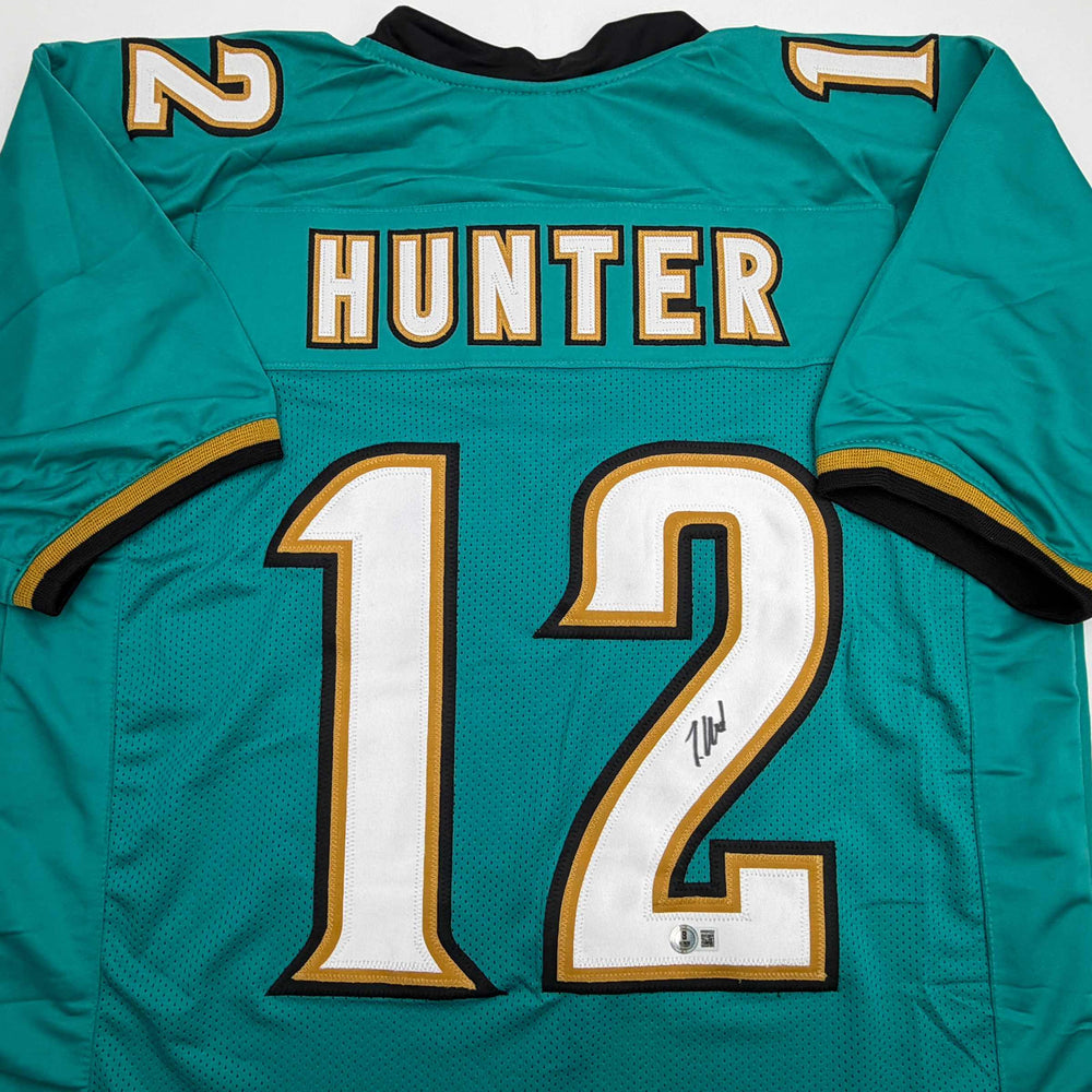 Autographed/Signed Travis Hunter Jacksonville Teal Retro Football Jersey Beckett BAS COA (ONLINE ORDER ONLY)