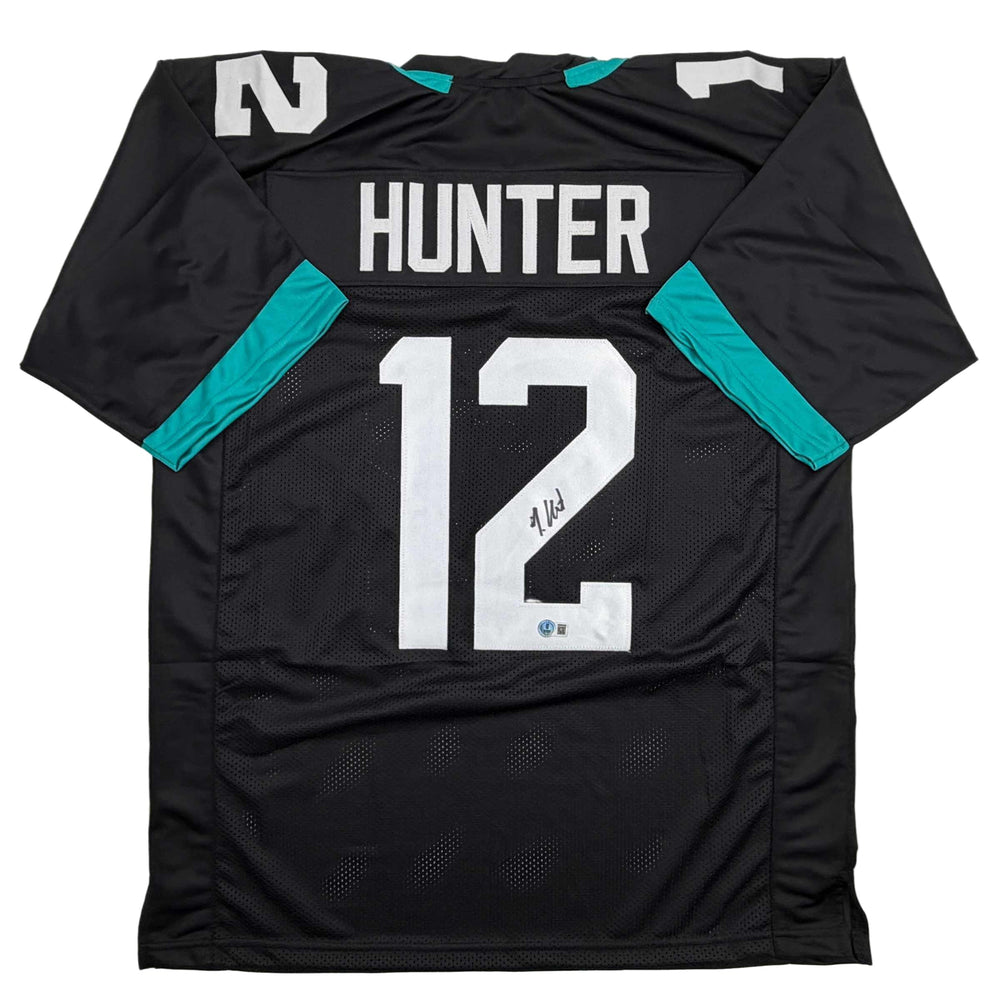 Autographed/Signed Travis Hunter Jacksonville Black Football Jersey Beckett BAS COA (ONLINE ORDER ONLY)