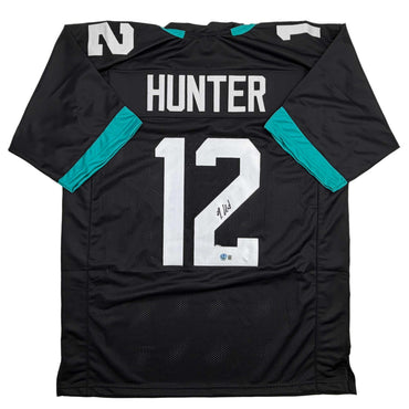 Autographed/Signed Travis Hunter Jacksonville Black Football Jersey Beckett BAS COA (ONLINE ORDER ONLY)