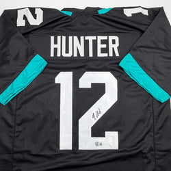Autographed/Signed Travis Hunter Jacksonville Black Football Jersey Beckett BAS COA (ONLINE ORDER ONLY)