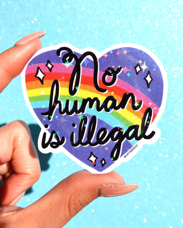 No Human Is Illegal Sticker – Rainbow Heart Holographic Vinyl Sticker (ONLINE ORDER ONLY)
